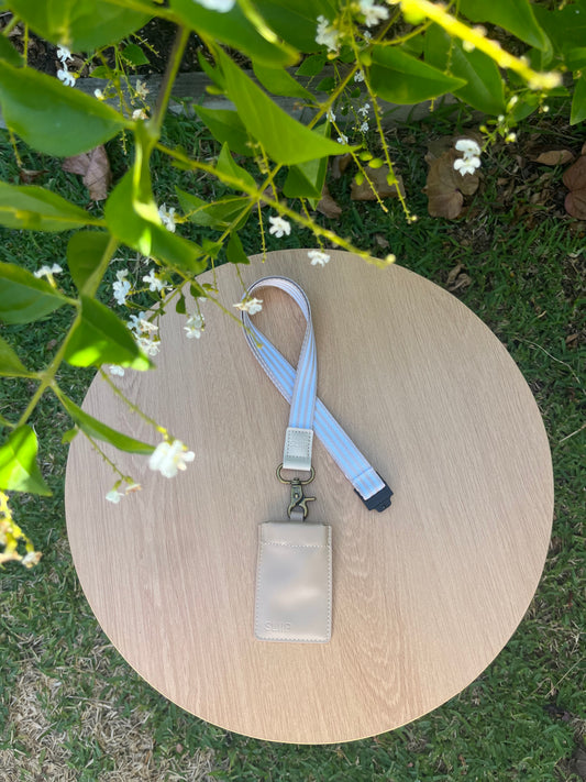 beige, sandy key pouch attached to beige and white striped lanyard, with gold clip