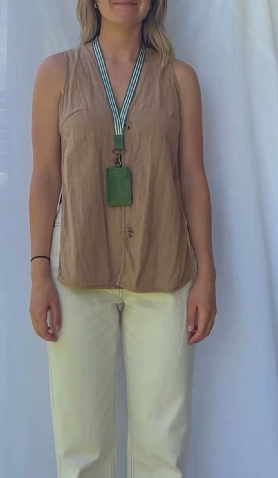 women wearing green and white striped lanyard and green, oliver key pouch