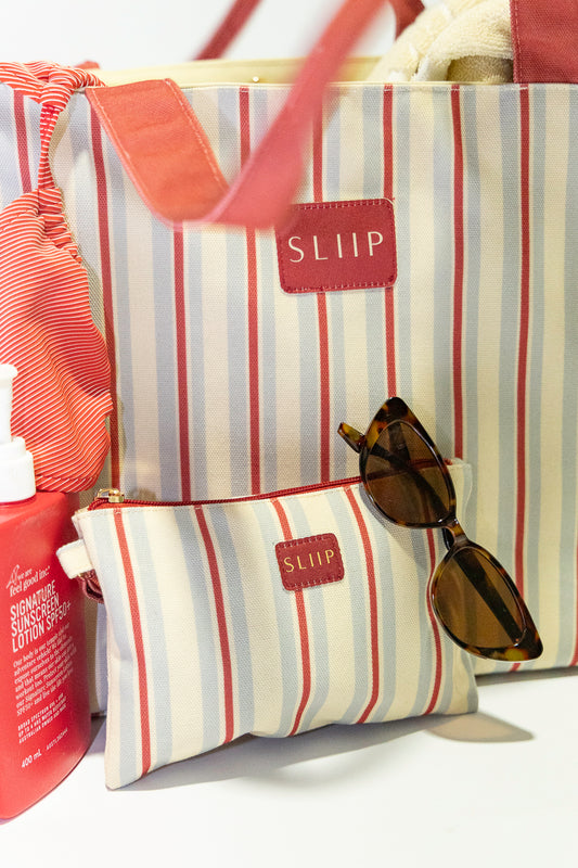 Matching small red, blue and beige striped bag next to large matching bag 