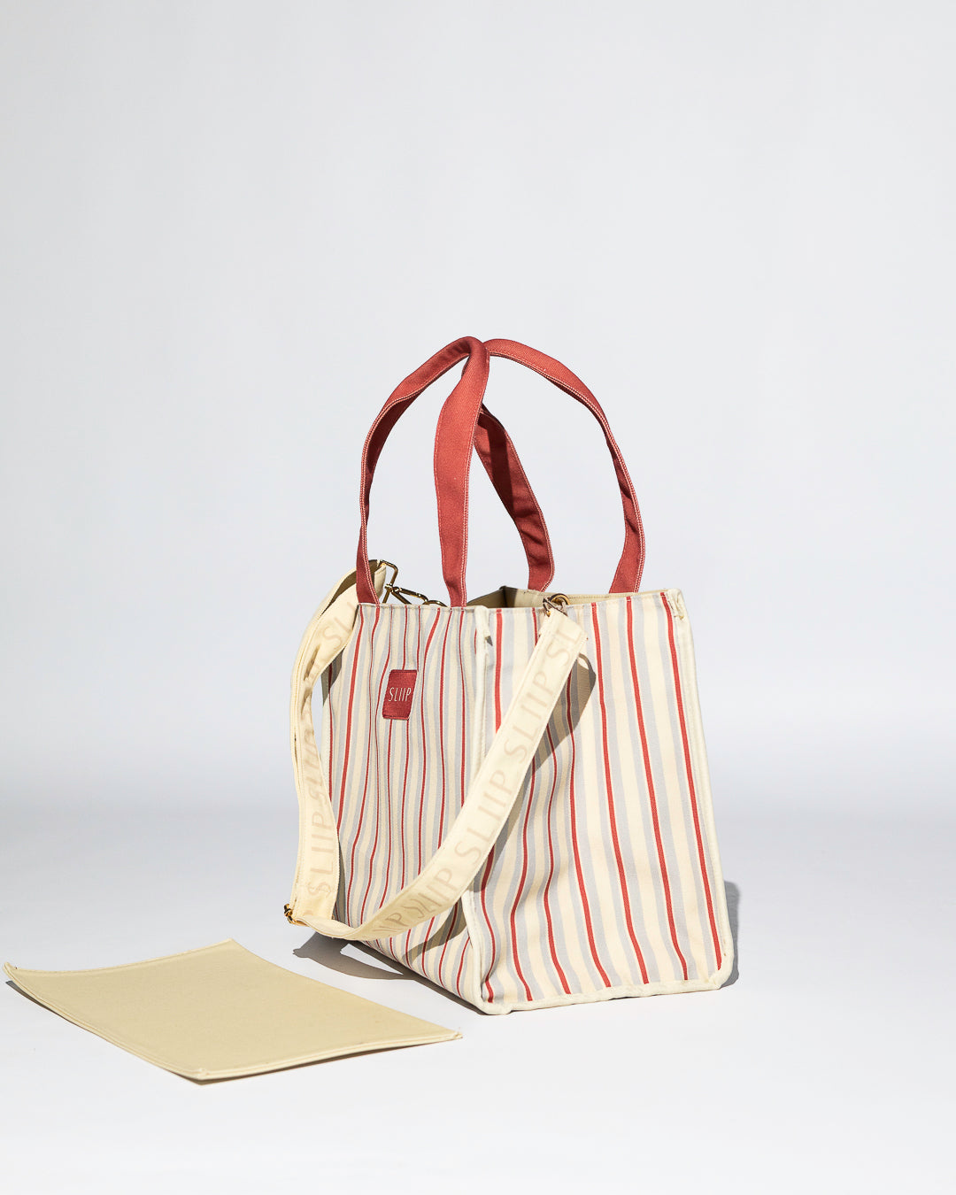 Striped tote bag with red handles and branded SLIIP shoulder strap 